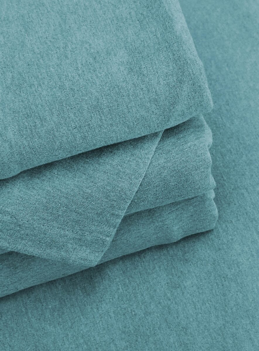 Close-up of neatly folded blue fabric, showcasing texture and color
